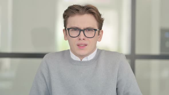 Portrait of Attractive Young Man Screaming Shouting