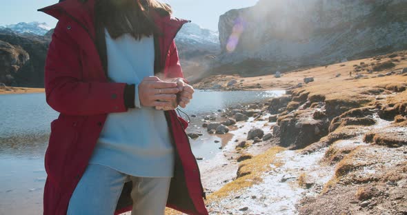 Traveler Young Woman Holding Cup with Hot Drink Tea on Mountain Trip