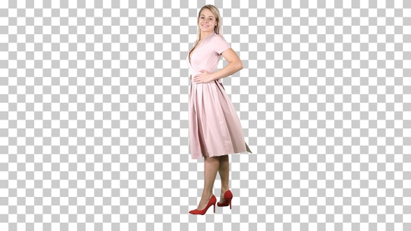 Woman in A Pink Dress Making a Turn and Looks at Her Self