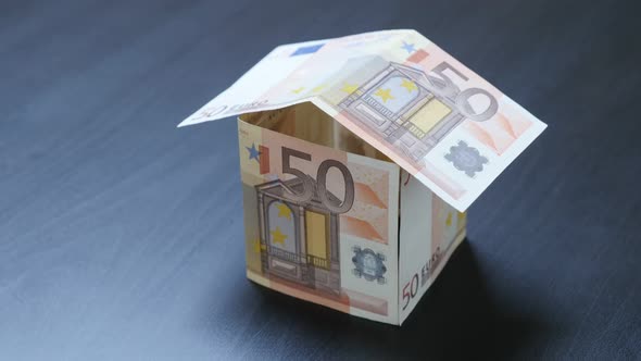 Investing European Union currency in real estate metaphor 4K 2160p 30fps UHD video - House shaped of