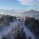 Aerial view of beautiful winter mountain snowy scenery. Cable car with skiers is riding - VideoHive Item for Sale