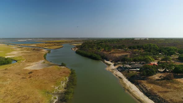 Aerial view of private residence near turbid river water, Brazil.