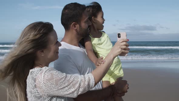 Happy Parents and Little Daughter Having Video Call