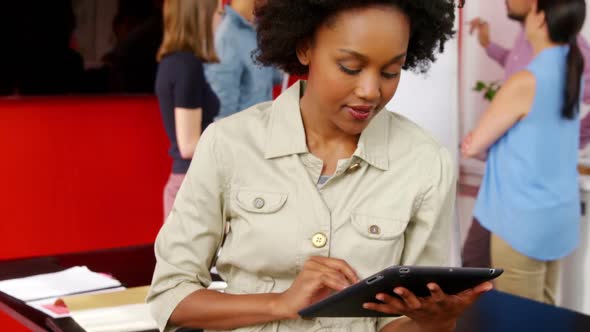 Female executive using digital tablet in the conference room