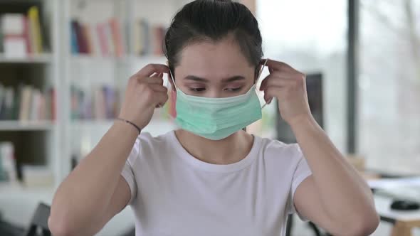 Portrait of Cautious Young Woman Wearing Face Mask