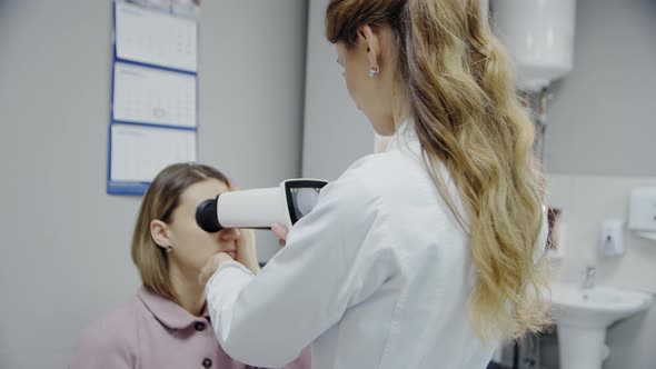 The Ophthalmologist Examines the Patient's Eye