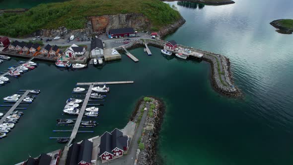 Aerial Tucking shot of Tonnes Marina, harbor in Helgeland Northern Norway on a calm day
