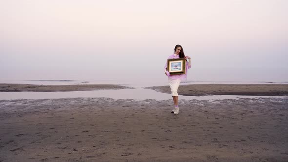 Motion To Woman Holding Picture in Frame on Sea Beach