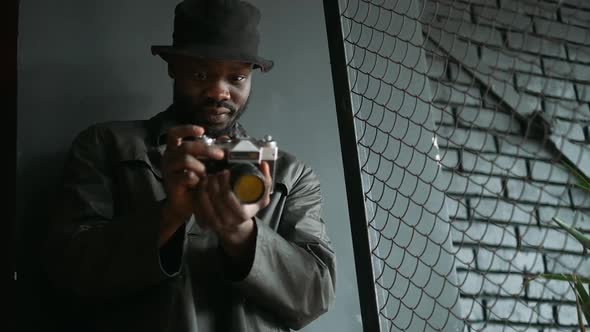 Young African American Taking Photos Indoors.