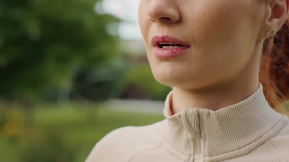 Close-up woman lips breathing relaxed in nature