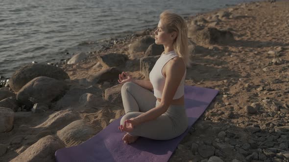 Meditation Girl on the Sea During Sunset. Fitness and Healthy Lifestyle. Yoga Practice