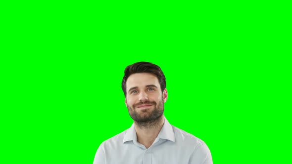 Young man standing against green screen