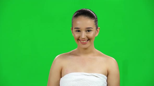 Attractive Young Woman in White Towel Laughing and Looking at the Camera, Green Screen