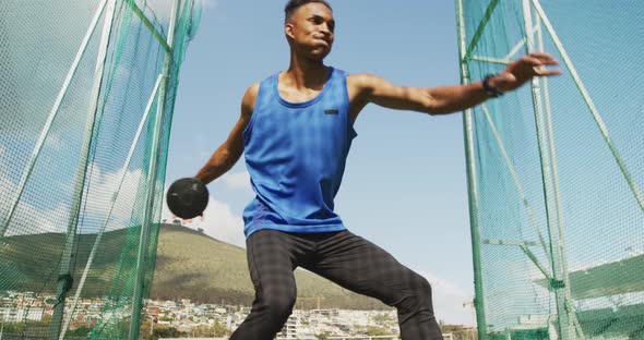 Mixed race athlete doing discus throw