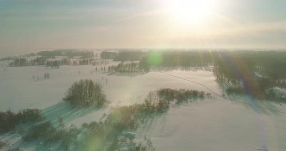 Aerial View of Cold Winter Landscape Arctic Field Trees Covered with Frost Snow Ice River and Sun