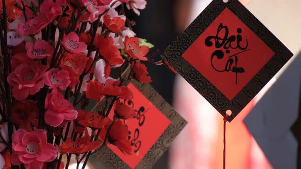 Vietnamese scholar writing calligraphy on the red envelope, ang pao in the lunar new year