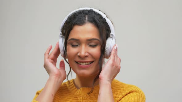 Happy Woman in Headphones Listening To Music