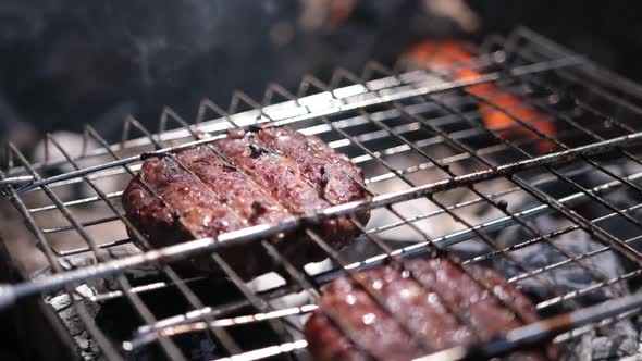 Beef Burgers Cutlets are Roasting on the Charcoal Barbecue Grill