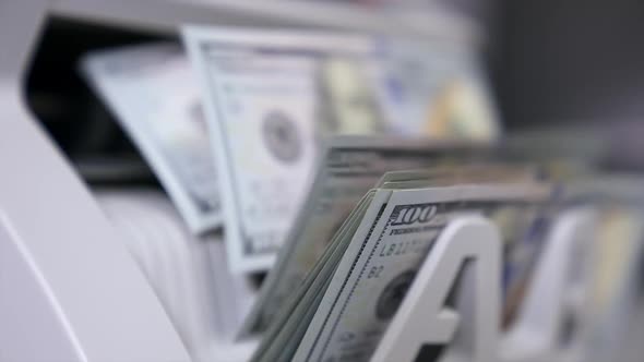 Close Up money counting machine. A bunch of american Banknotes. The world currency is the US dollar.