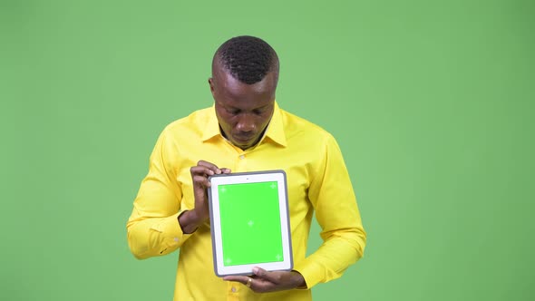 Young Happy African Businessman Showing Digital Tablet