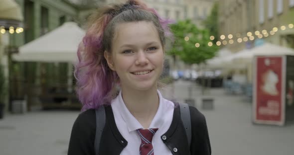 Teenager Girl in School Uniform with Backpack Walking and Smiling