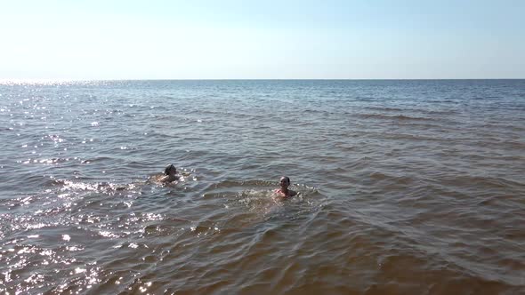 Aerial View: Two Women in Swimsuits Having Fun in Sea