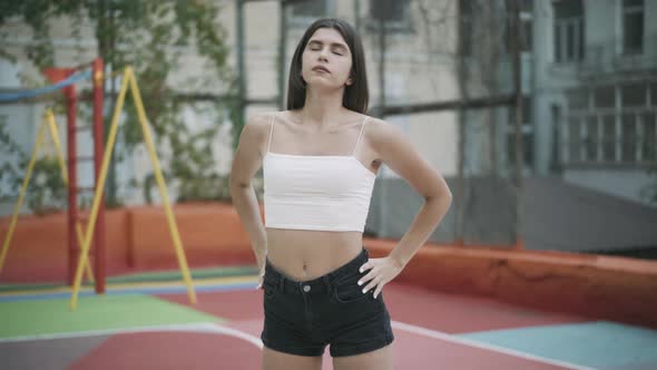 Camera Moving Around Fit Caucasian Young Woman Stretching Warming Up Before Training Outdoors