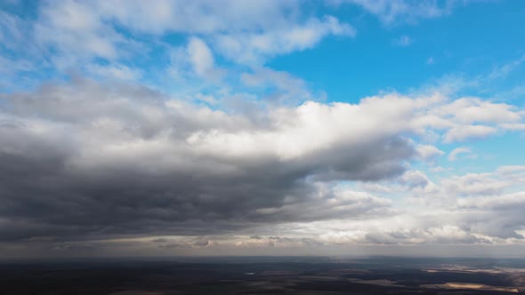 Aerial View From High Altitude of Earth Covered with Puffy Rainy Clouds Forming Before Rainstorm