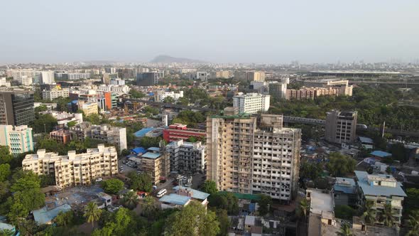 drone shot birds-eye view andheri marol metro station train side view Mumbai India wide angle  green