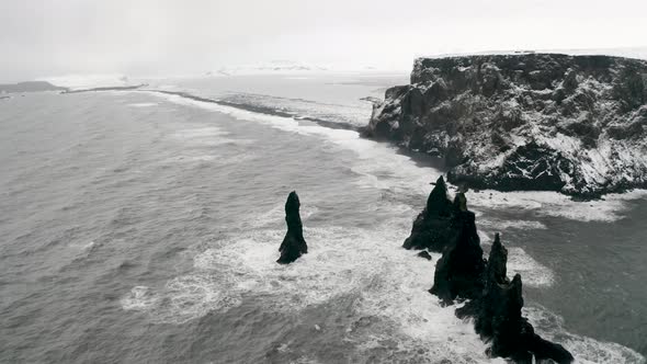 Aerial View of Black Sand Beach in Cloudy Weather. The Beginning of Spring in Iceland