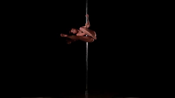 Sexy Female Pole Dancing on Black Background