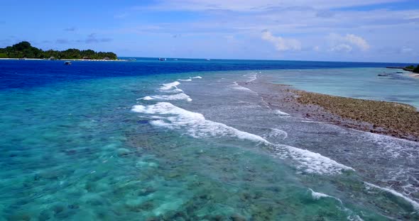 Natural drone island view of a sunshine white sandy paradise beach and blue sea background in vibran