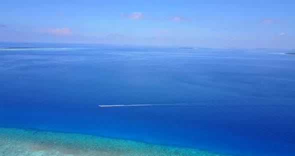 Daytime birds eye travel shot of a summer white paradise sand beach and blue ocean background