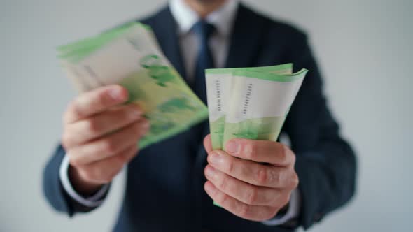 Formally Dressed Man Counting Euro Banknotes Closeup