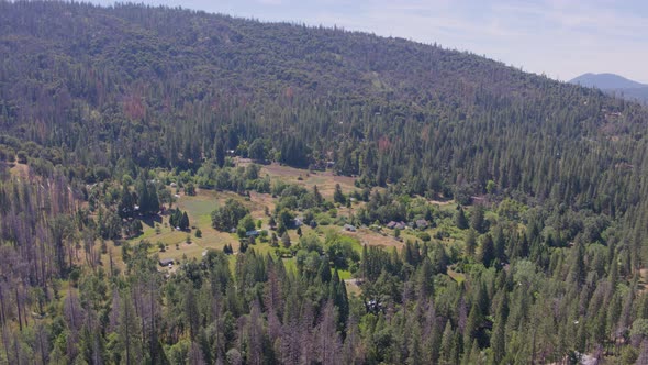 Descending Aerial Drone Shot of Houses in a California Mountain Valley (Sierra National Forest, CA)