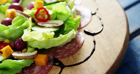 Salad decorated on wooden plate