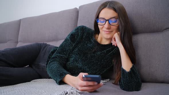 White woman using modern smartphone for online dating and communication on social media app in 4k