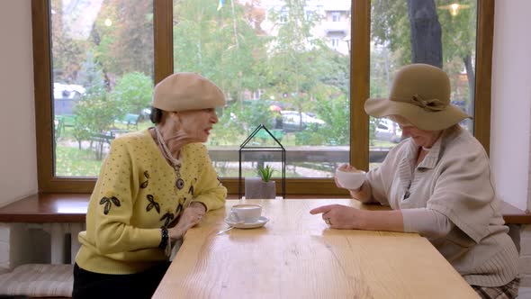 Elderly Women and Cafe Table