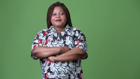 Overweight Beautiful African Woman Against Green Background