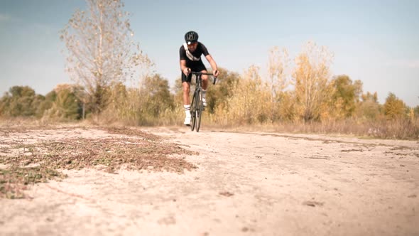 Cyclist Riding On Gravel Bike In Slow Motion. Cyclist Athlete Workout Riding On Gravel Bicycle.