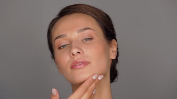 Beautiful Young Woman Touching Her Face