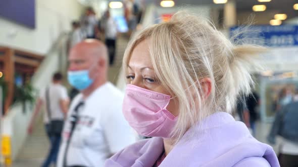 Woman Wearing Medical Protective Mask in Airport Terminal