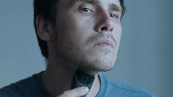 Man Shaving With Electric Razor