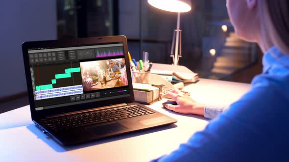 Editor Working on Video File on Laptop at Night 8