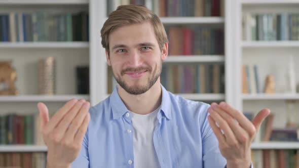 Portrait of Man Pointing at the Camera and Inviting