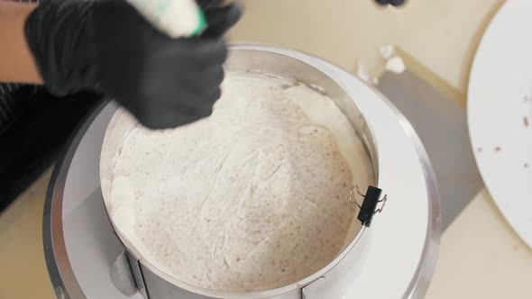 Confectioner Squeezes Vanilla Cream on the Cake