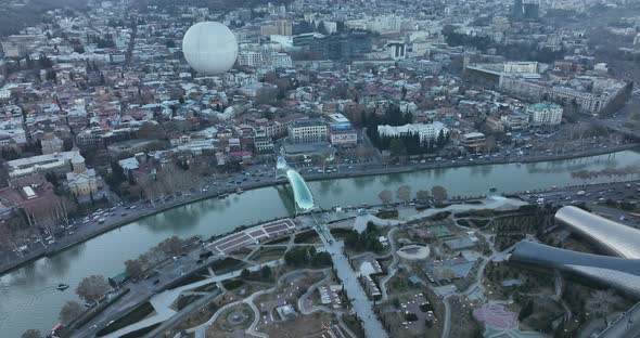 Aerial view of Tbilisi city central park and Bridge of Peace. Beautiful cityscape of old Tbilisi