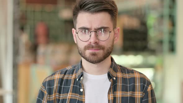 Portrait of Young Man Saying No By Head Shake 