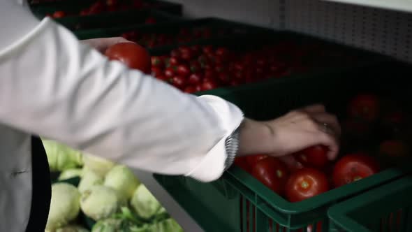 The Woman in the Masked Shop Chooses the Tomato