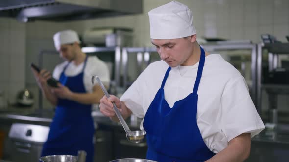 Cook Tasting Soup in Slow Motion with Ladle Smiling Enjoying Taste